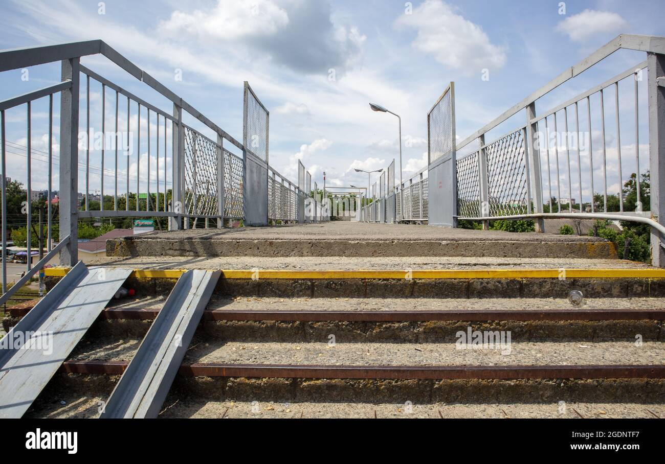 Railway bridge with steps, with impressive steps in perspective. Overhead pedestrian crossing