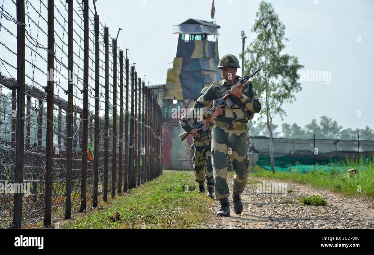 Border Security Force (BSF) personnel patrolling along the barbed wire