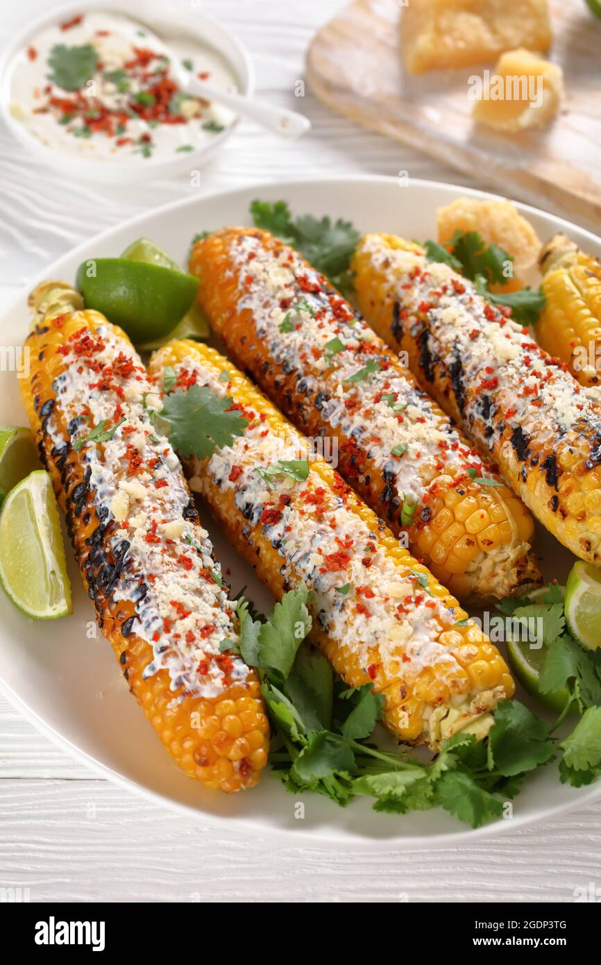 Elotes, Grilled Mexican Street Corn, charred cobs are covered in creamy