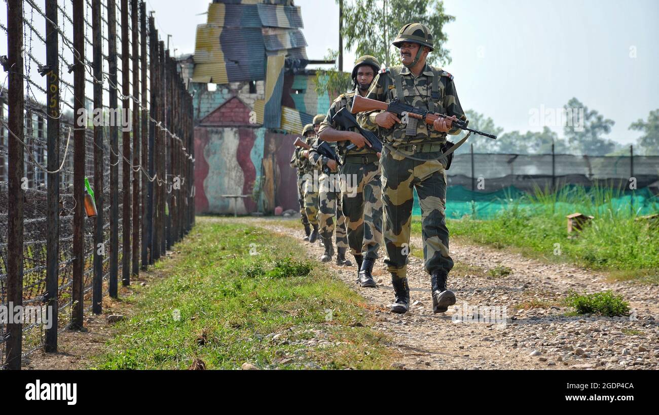 Border Security Force (BSF) personnel patrolling along the barbed wire