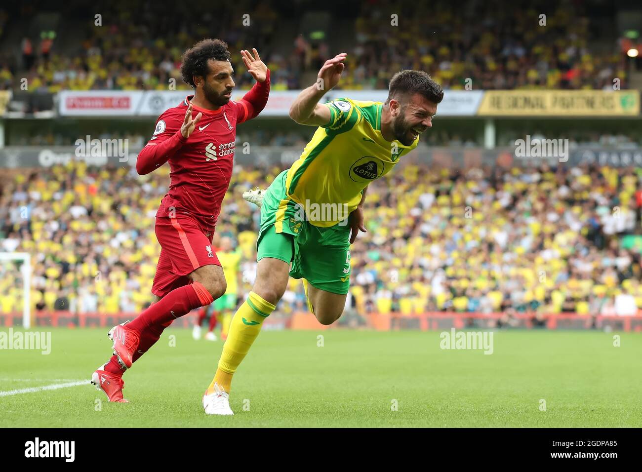 Carrow Road, Norwich, Norfolk, UK. 14th Aug, 2021. Premier League football, Norwich versus Liverpool; Mohamed Salah of Liverpool fouls Grant Hanley of Norwich City Credit: Action Plus Sports/Alamy Live News Stock Photo