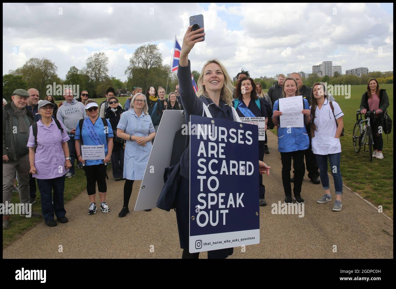 Nurse Jenna Platt takes a selfie with health professionals and their supporters in Hyde Park.Jenna is currently walking around the UK wearing a sandwich board that encourages debate, visiting all 69 cities to highlight how Covid care has left nurses unhappy and too scared to question policy for fear of losing their jobs. Some health workers have spoken of bullying, coercion and being ostracised. Many feel if they ask questions, they are seen as being part of the problem. Jenna delivered a letter of complaint to The Nursing Midwifery Council in London before she embarked on her city tour, askin Stock Photo