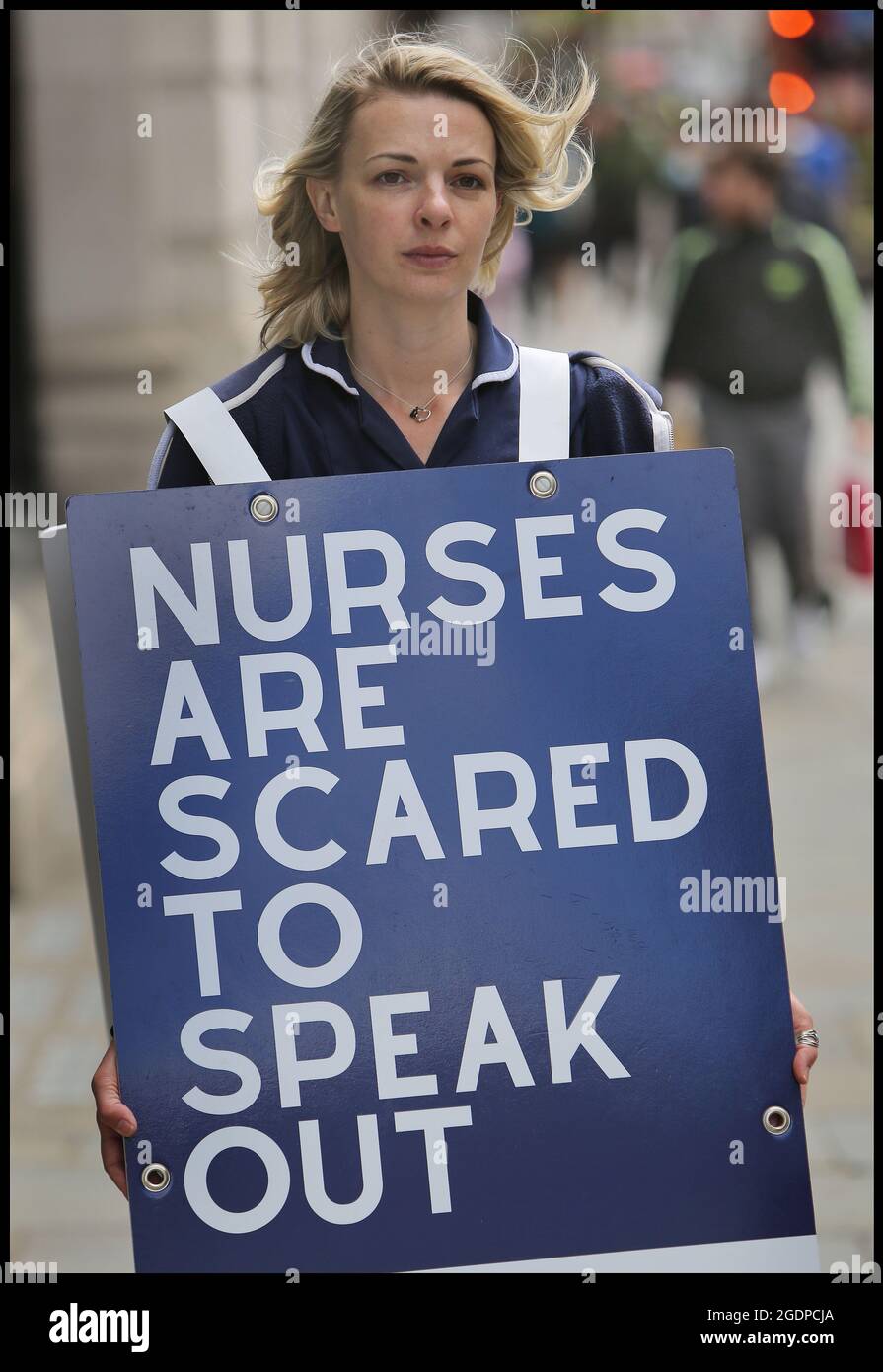 London, UK. 7th May, 2021. Nurse Jenna Platt engages with members of the public in Regent Street.Jenna is currently walking around the UK wearing a sandwich board that encourages debate, visiting all 69 cities to highlight how Covid care has left nurses unhappy and too scared to question policy for fear of losing their jobs. Some health workers have spoken of bullying, coercion and being ostracised. Many feel if they ask questions, they are seen as being part of the problem. Jenna delivered a letter of complaint to The Nursing Midwifery Council in London before she embarked on her c Stock Photo
