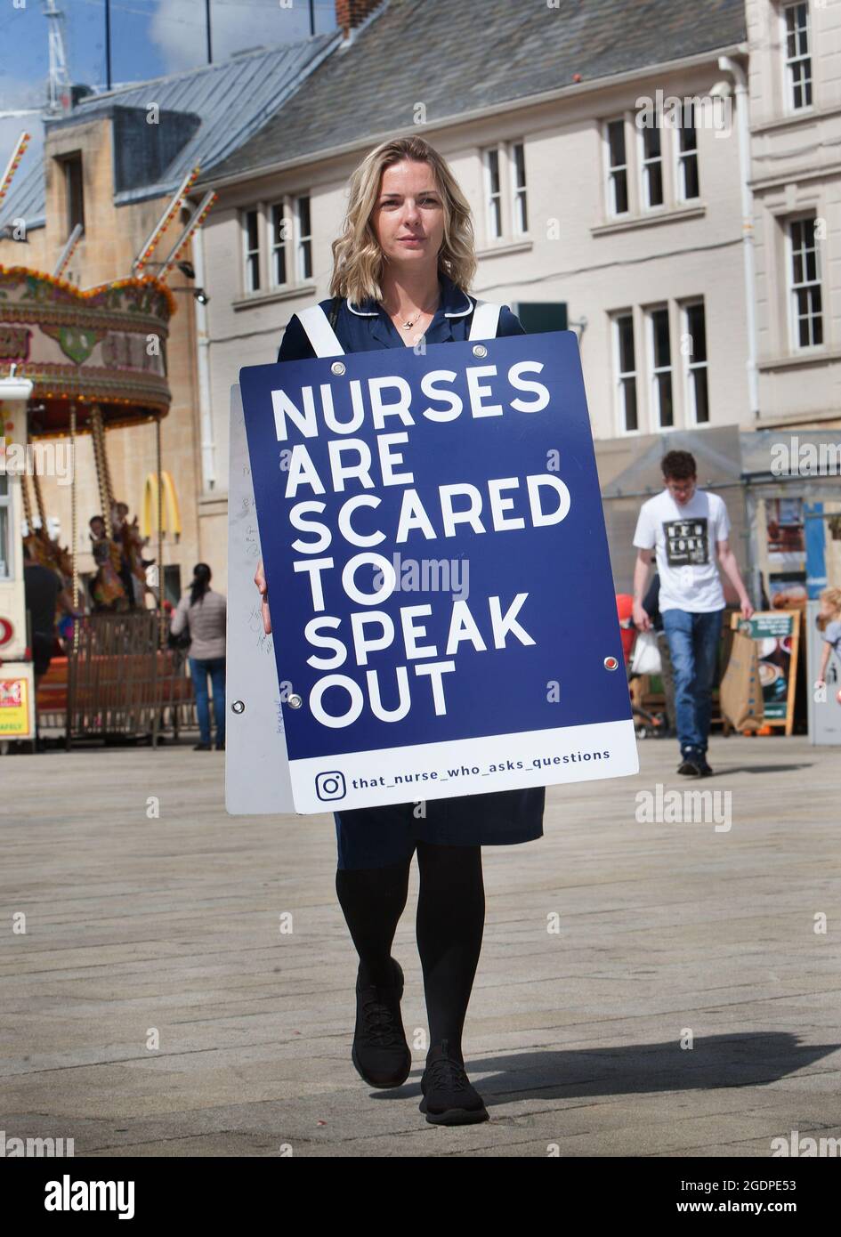 Nurse, Jenna Platt in Peterborough walking across the Central Square