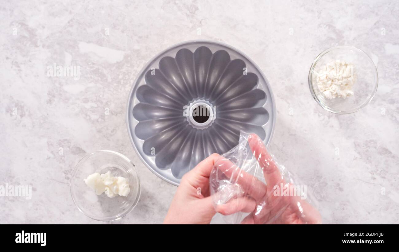 Flat lay. Step by step. Greasing bundt cake pan with vegetable ...