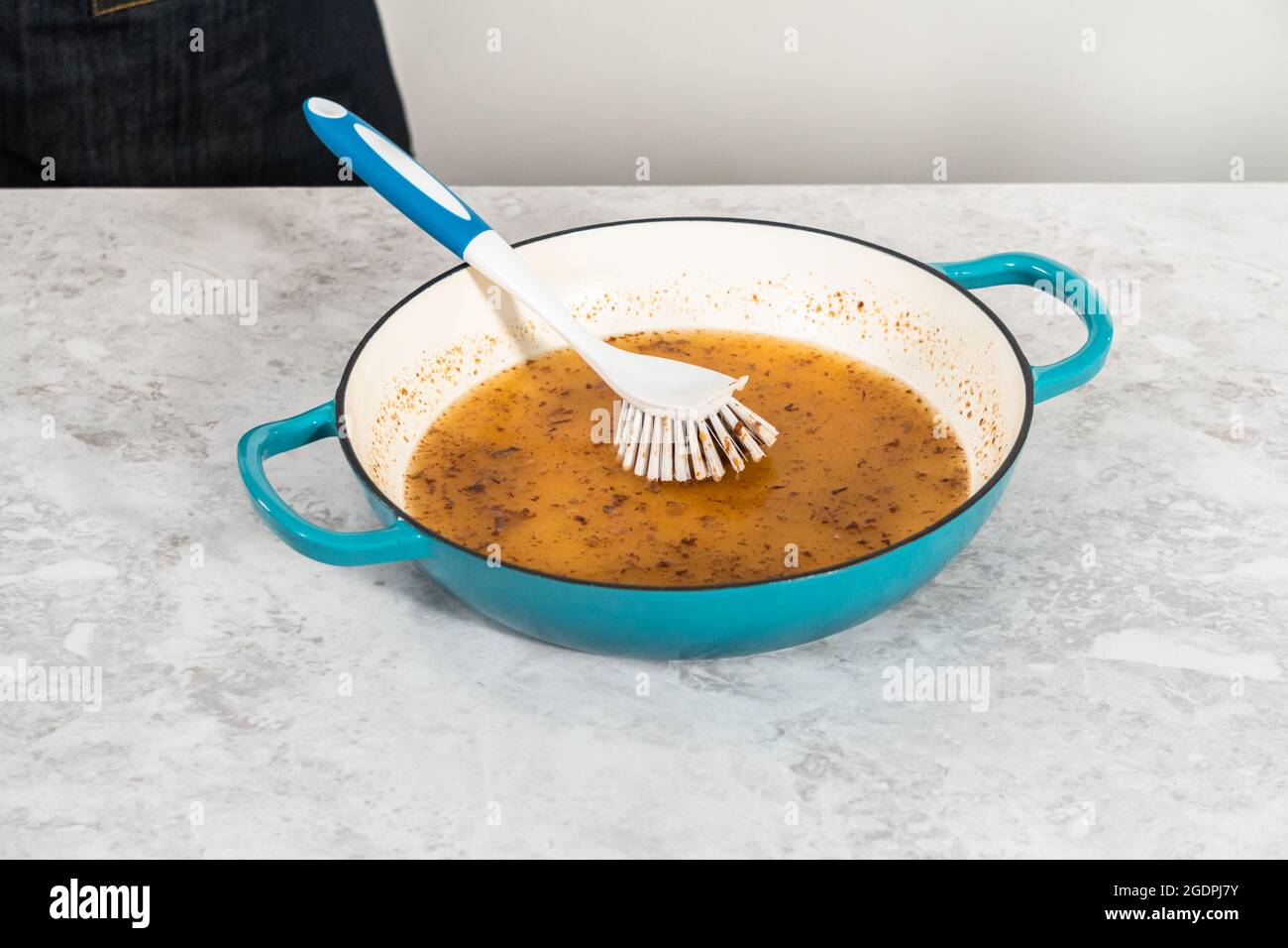 Cleaning cast iron enameled braiser with baking soda and vinegar Stock