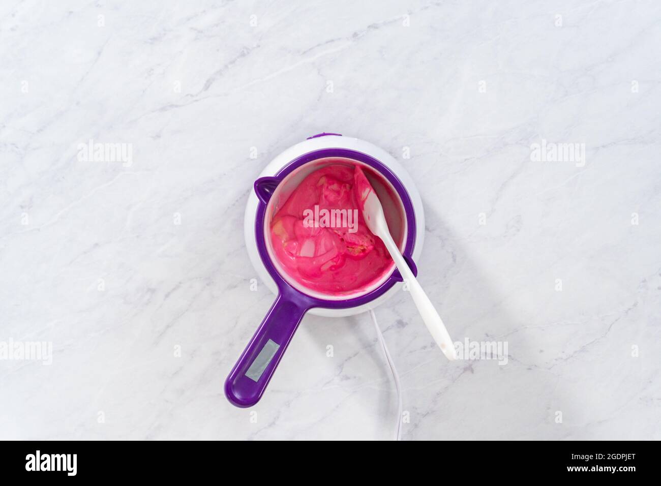 Flat lay. Melting pink chocolate melts to make mini pink chocolates