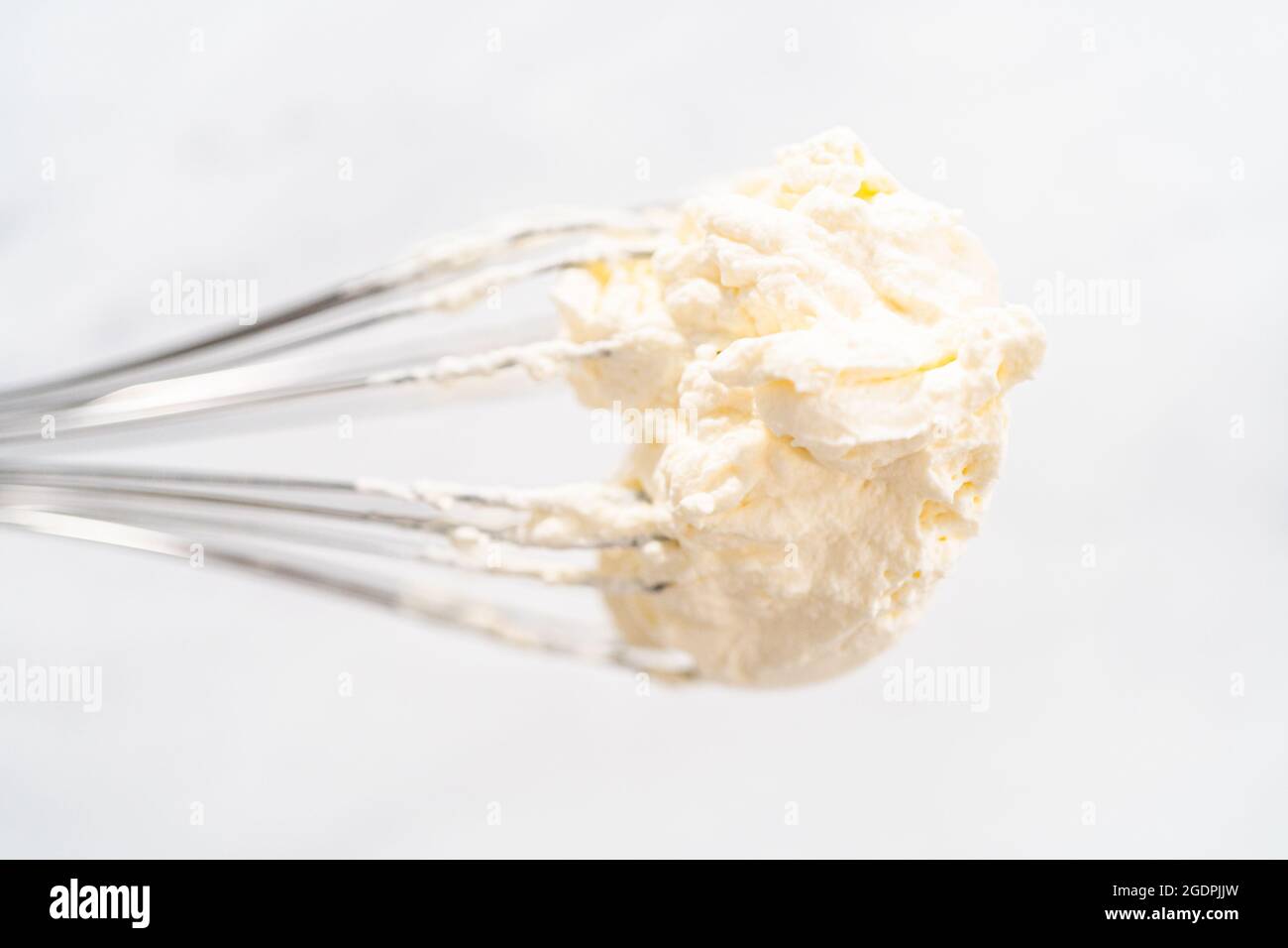 Whisk with homemade whipped cream. Freshly whipped Stock Photo Alamy