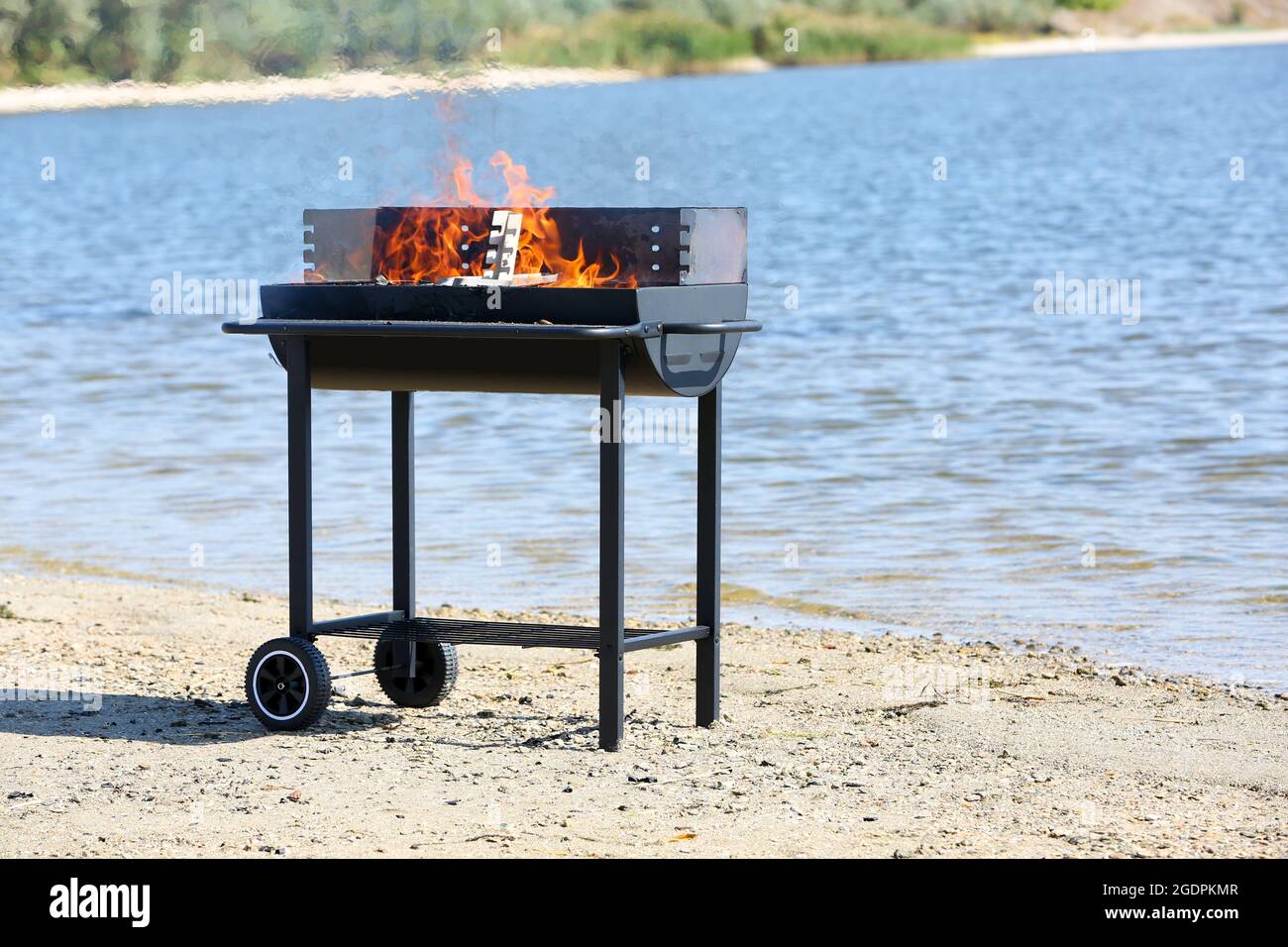 Barbecue grill on beach of river Stock Photo Alamy