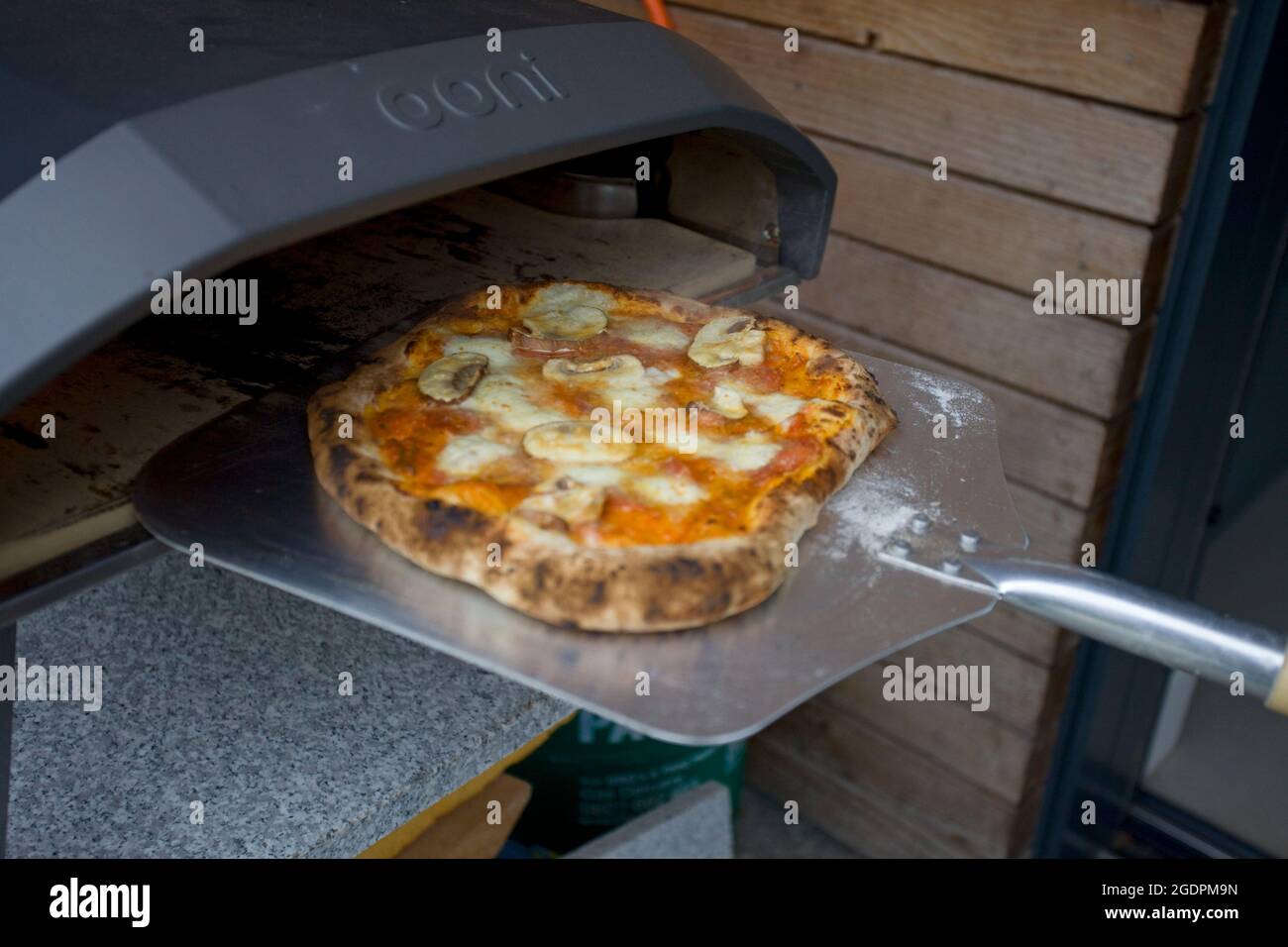 OONI Pizza oven with cooked pizza Stock Photo