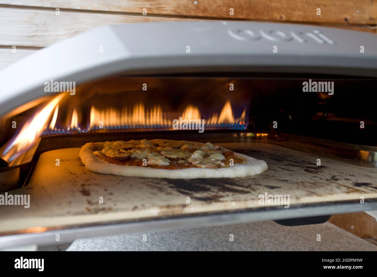 OONI Pizza oven with cooking pizza Stock Photo