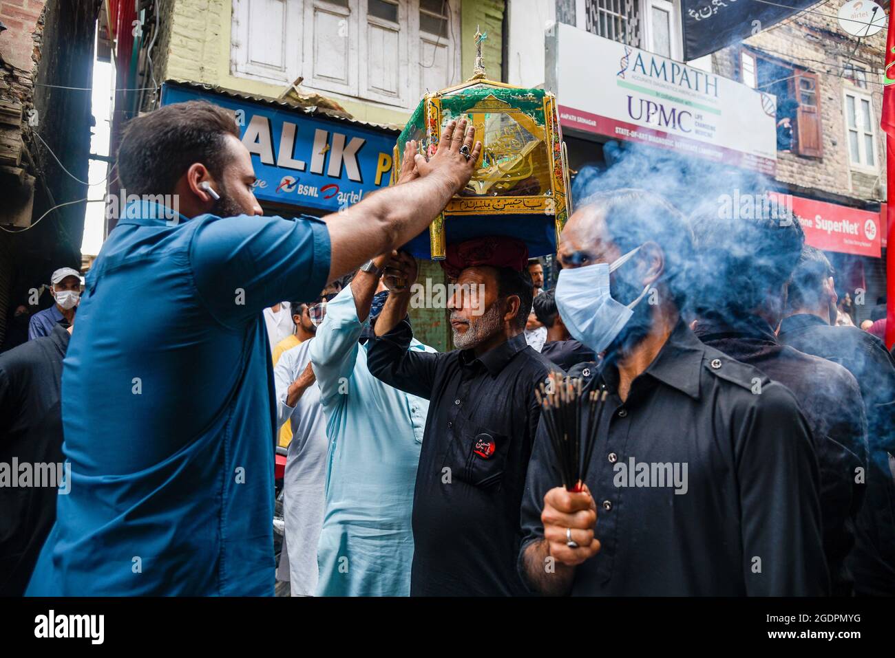 Srinagar, India. 14th Aug, 2021. A man touches the glass case ...