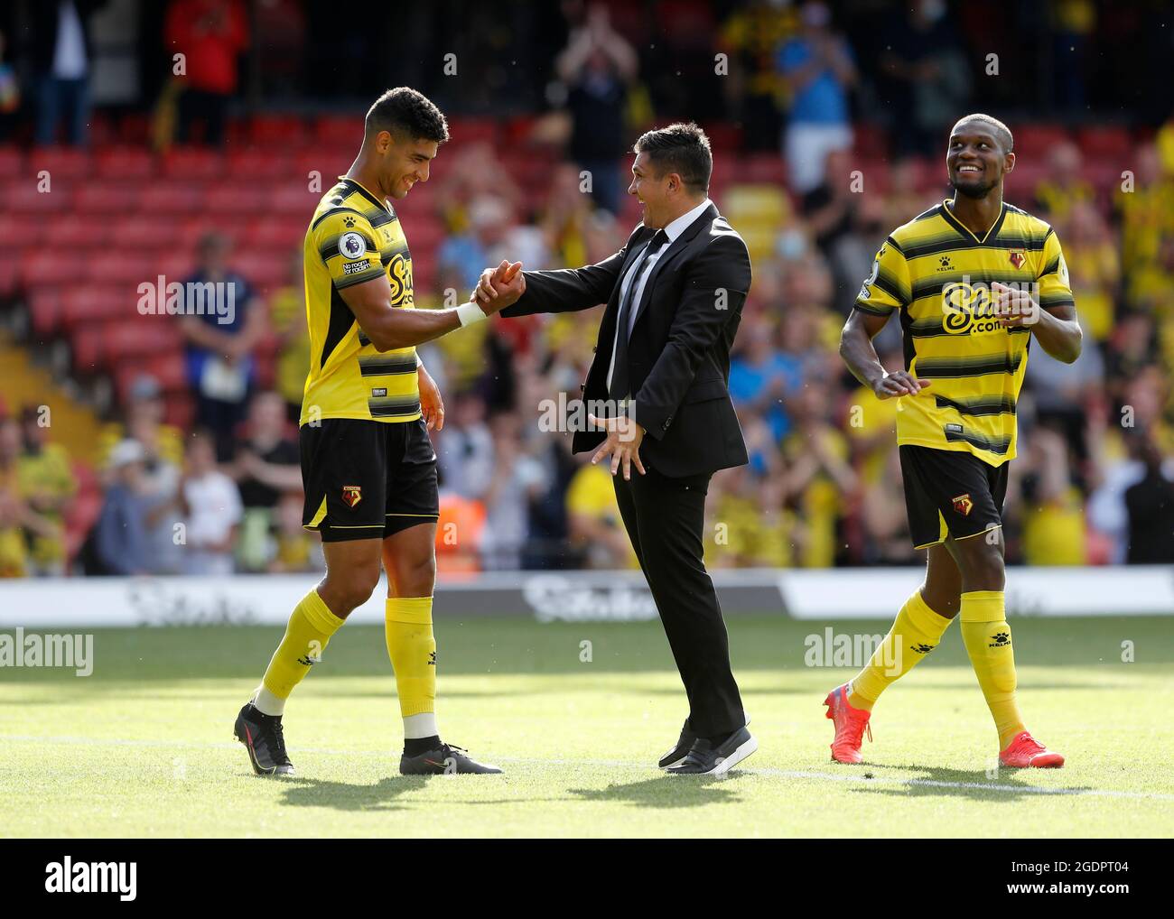 14th August 2021; Vicarage Road Stadium, Watford, Herts, England; Premier League football, Watford versus Aston Villa; Watford Manager Xisco Munoz celebrates with Adam Masina and Christian Kabasele of Watford after the final whistle Stock Photo