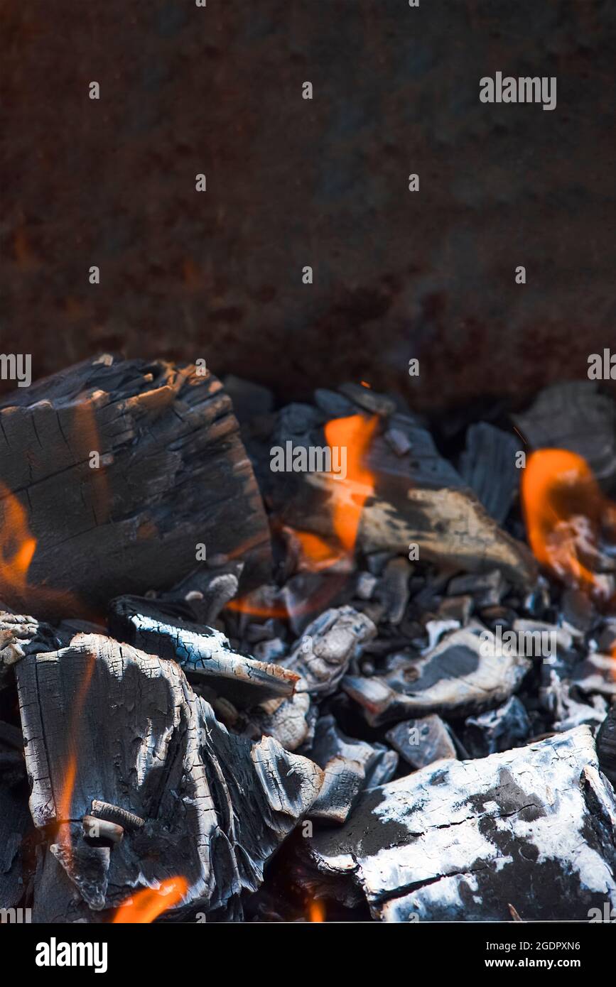 Bonfire embers. BBQ coals with fire. Close-up of the combustion process of wood, charcoal for barbecue Stock Photo