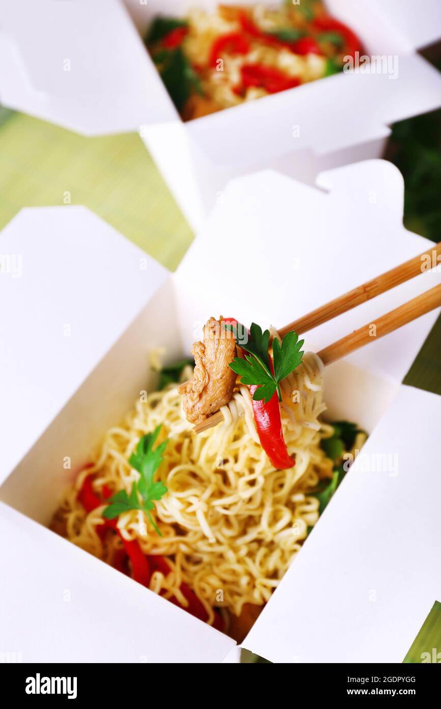 Chinese noodles and sticks in takeaway boxes closeup Stock Photo Alamy