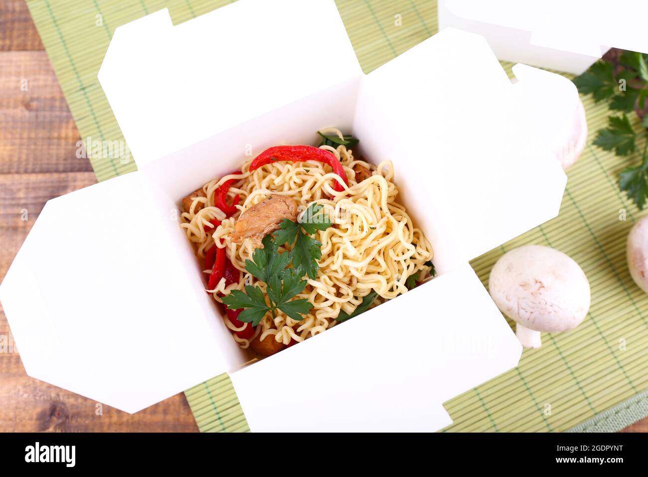 Chinese noodles in takeaway box on mat background Stock Photo Alamy