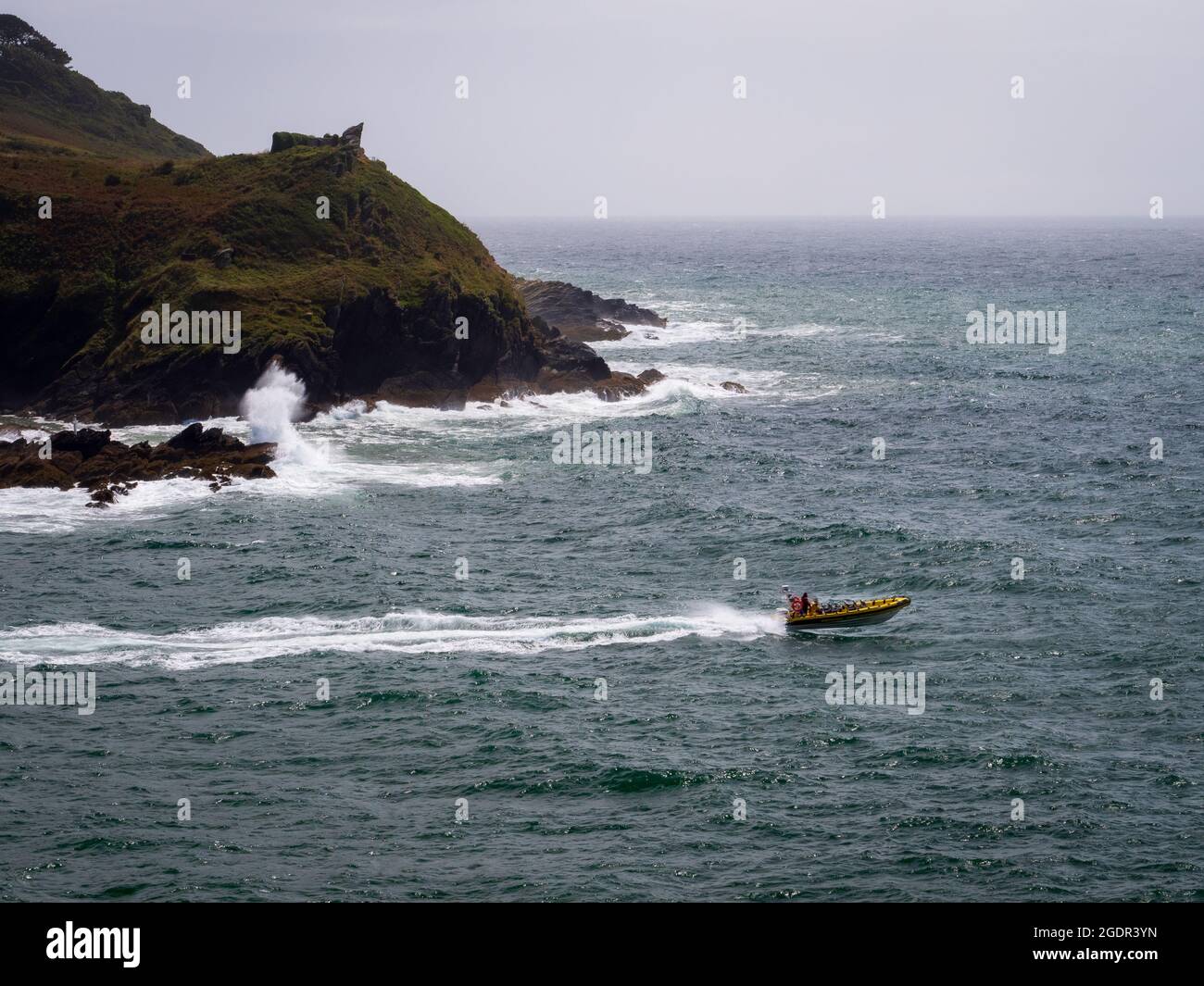 A speed boat exiting the estuary into the English Channel at Fowey in Cornwall Stock Photo