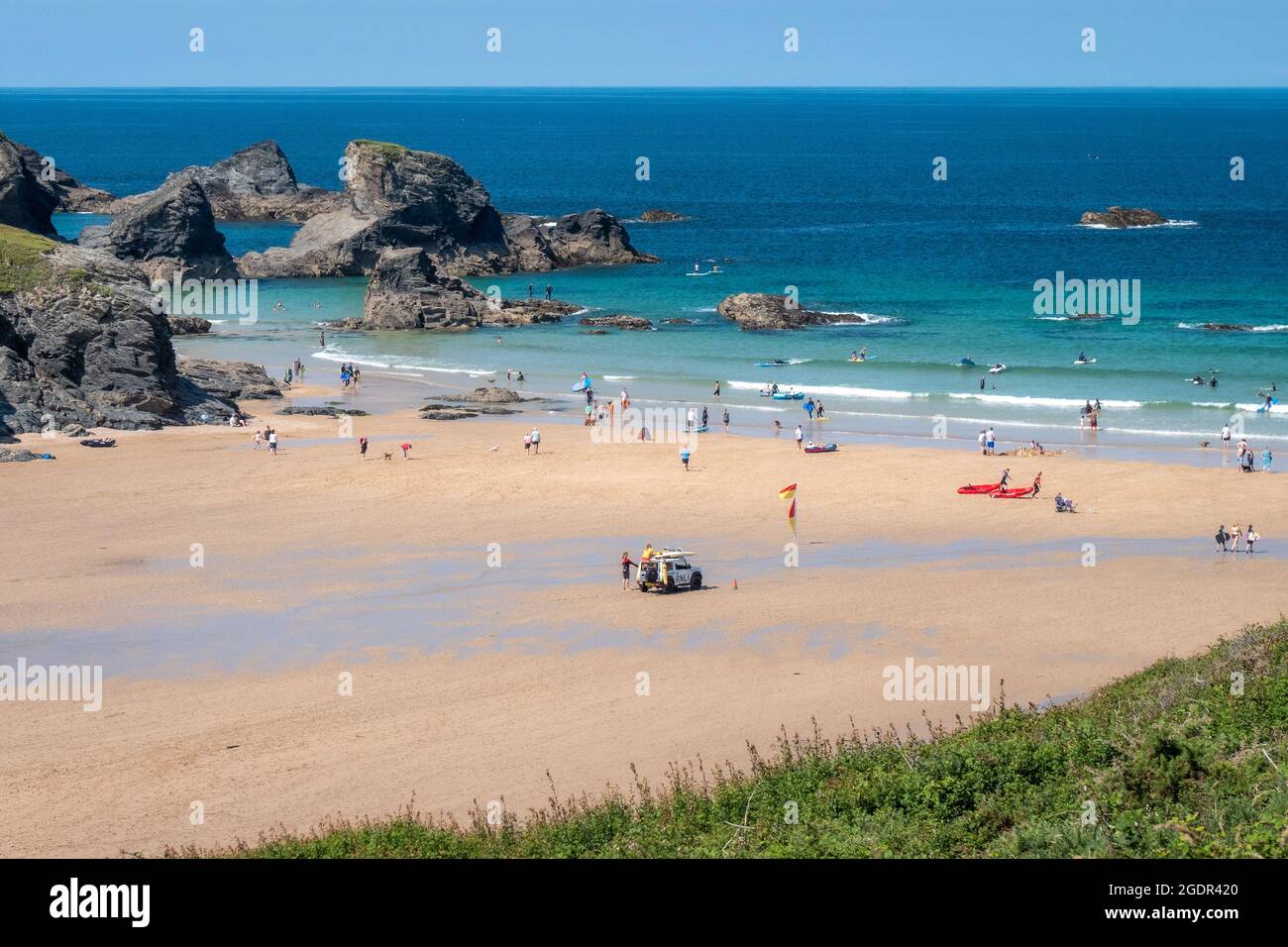 Looking down the beach from the cliffs above Cornwall's Porthcothan bay on beautiful summer's day Stock Photo