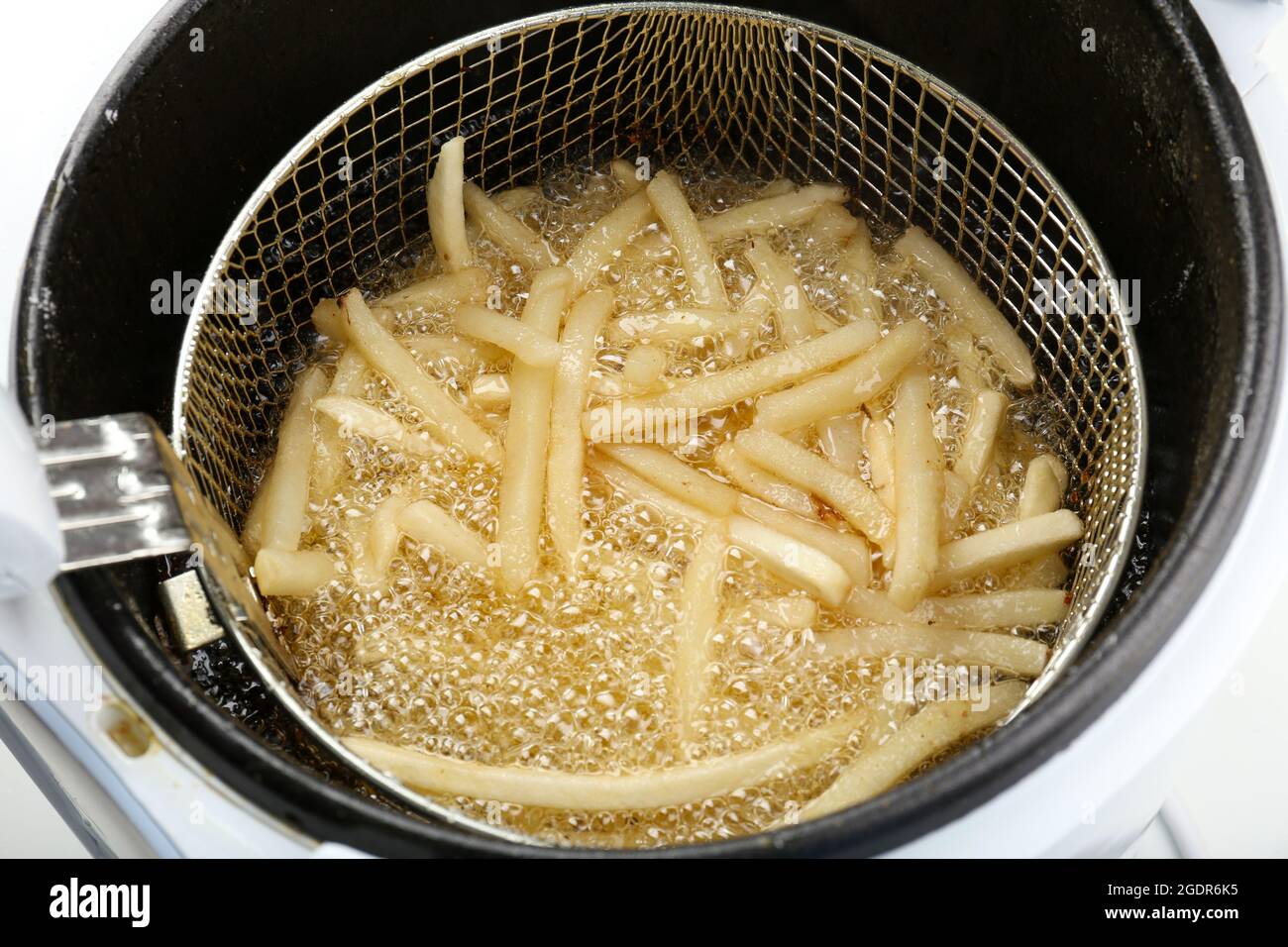 French fries in deep fryer, closeup Stock Photo Alamy