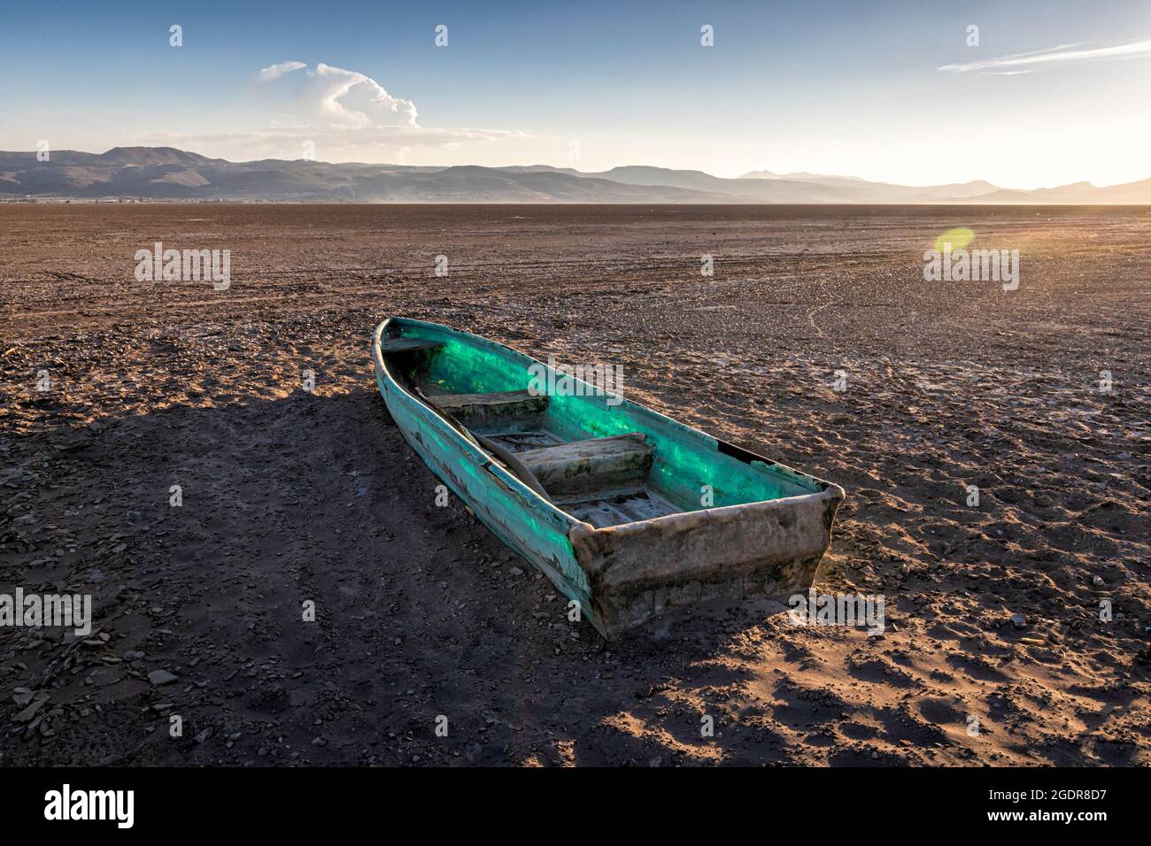 A lone boat sits in the middle of a dried out lake bed in Michoacan, Mexico. Stock Photo