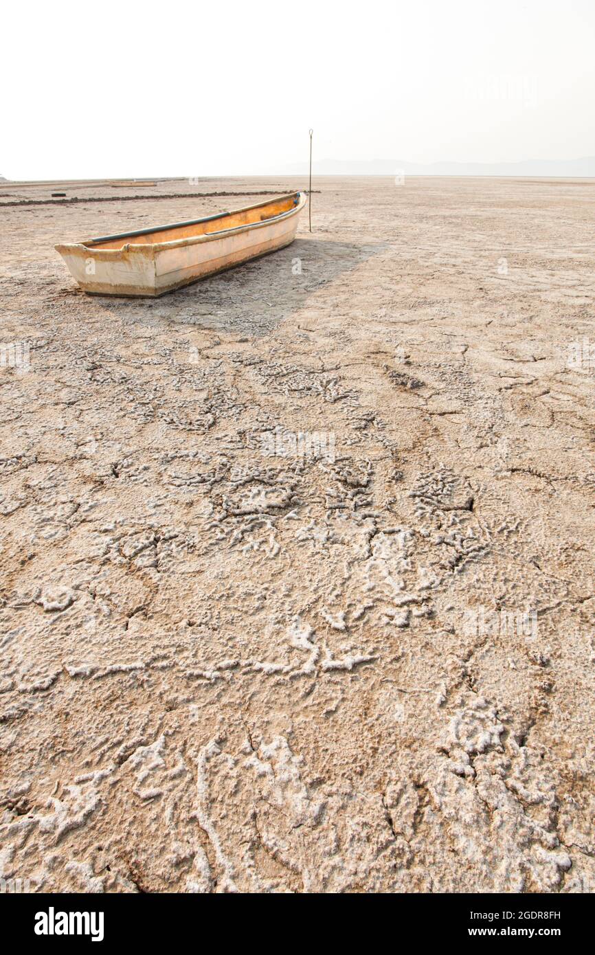 A fishing boat sits useless on the dry lake bed of Lake Cuitzeo, Michoacan, Mexico. Stock Photo