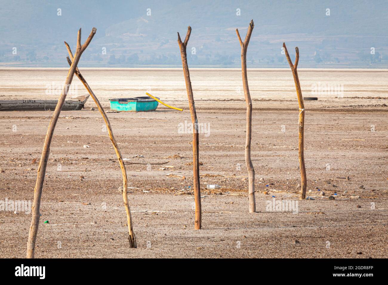 An abandoned fishing boat sits useless on the dry lake bed of Lake Cuitzeo, Michoacan, Mexico. Stock Photo