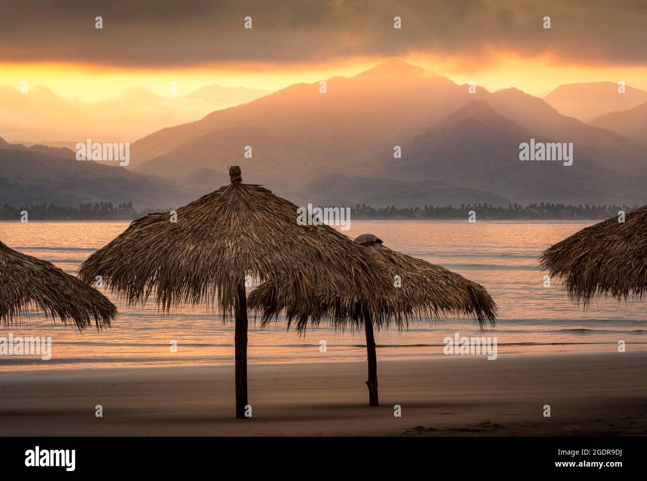 Sunrise over palapas on the Islitas Beach of the Pacific coast of Mexico near San Blas. Stock Photo