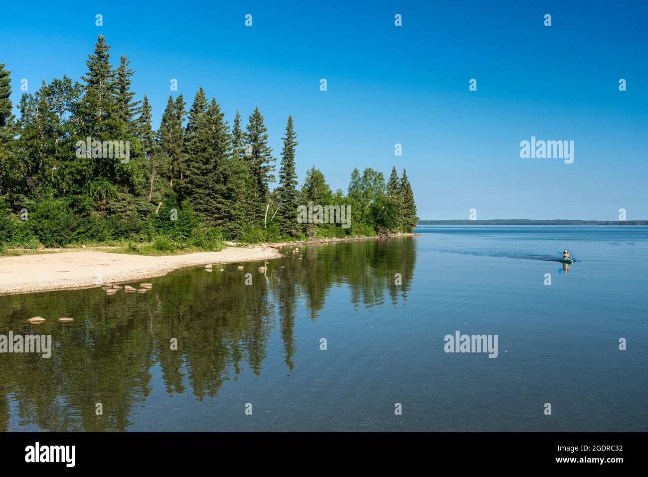 The shoreline of Clear Lake with reflections in Riding Mountain