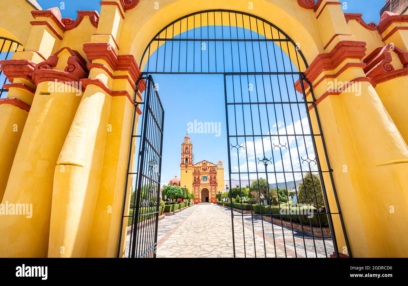 Yellow gate and church of Tamazulapam, Oaxaca, Mexico. Stock Photo