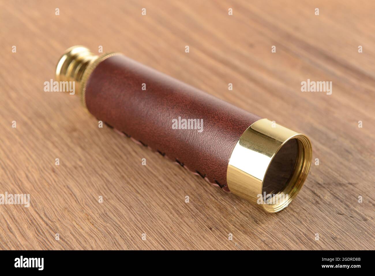 Modern spyglass on wooden background Stock Photo - Alamy