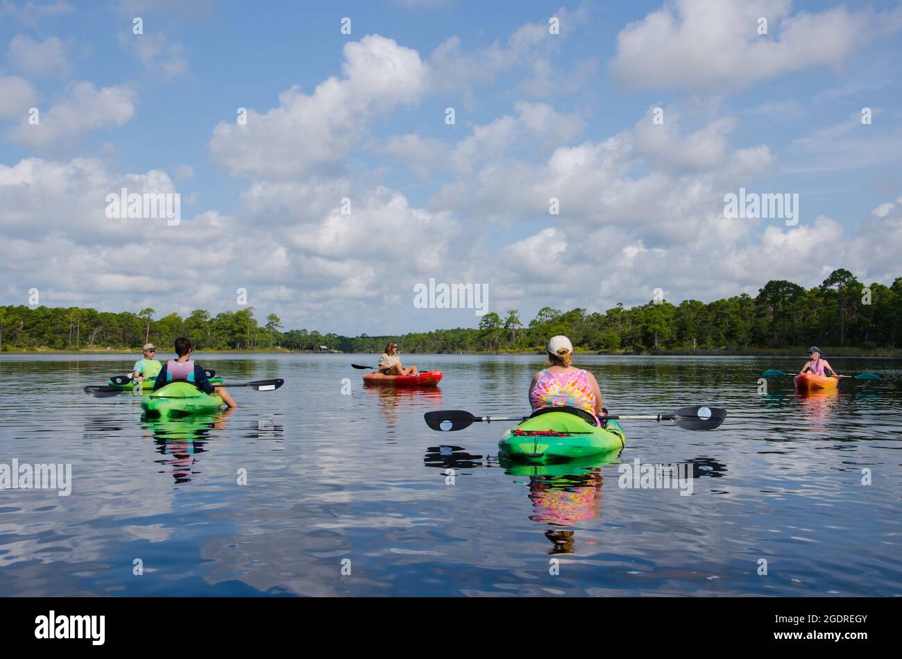 A park ranger leads a kayaking eco tour on Lake Powell, North America's largest coastal dune lake, in Camp Helen State Park, Florida, USA Stock Photo