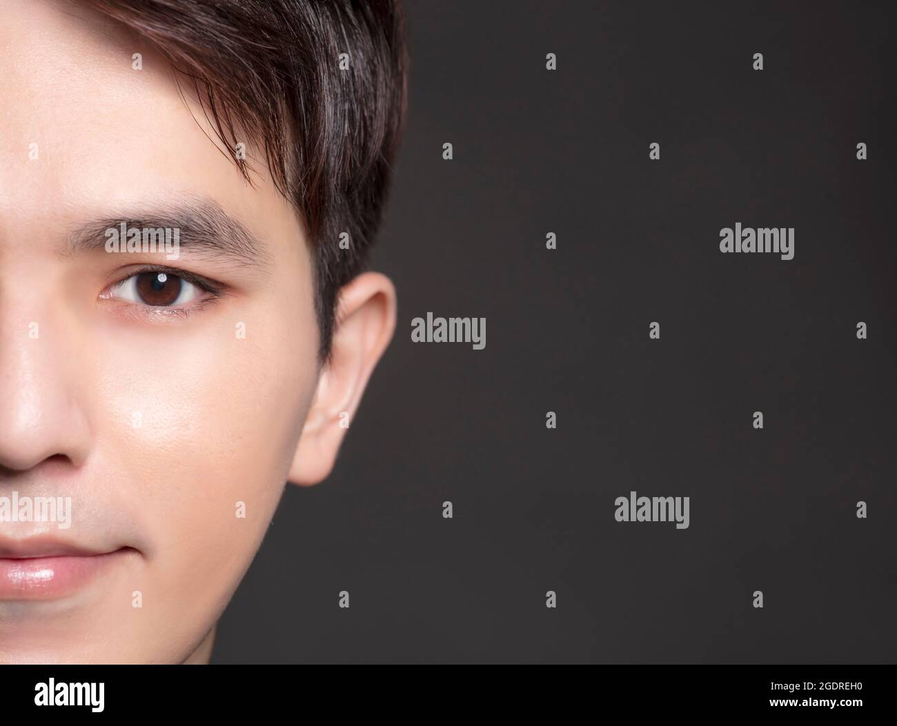 Half face of Asian young man Stock Photo