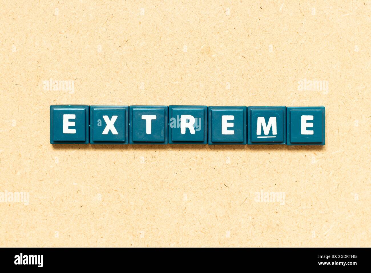 Tile alphabet letter in word extreme on wood background Stock Photo