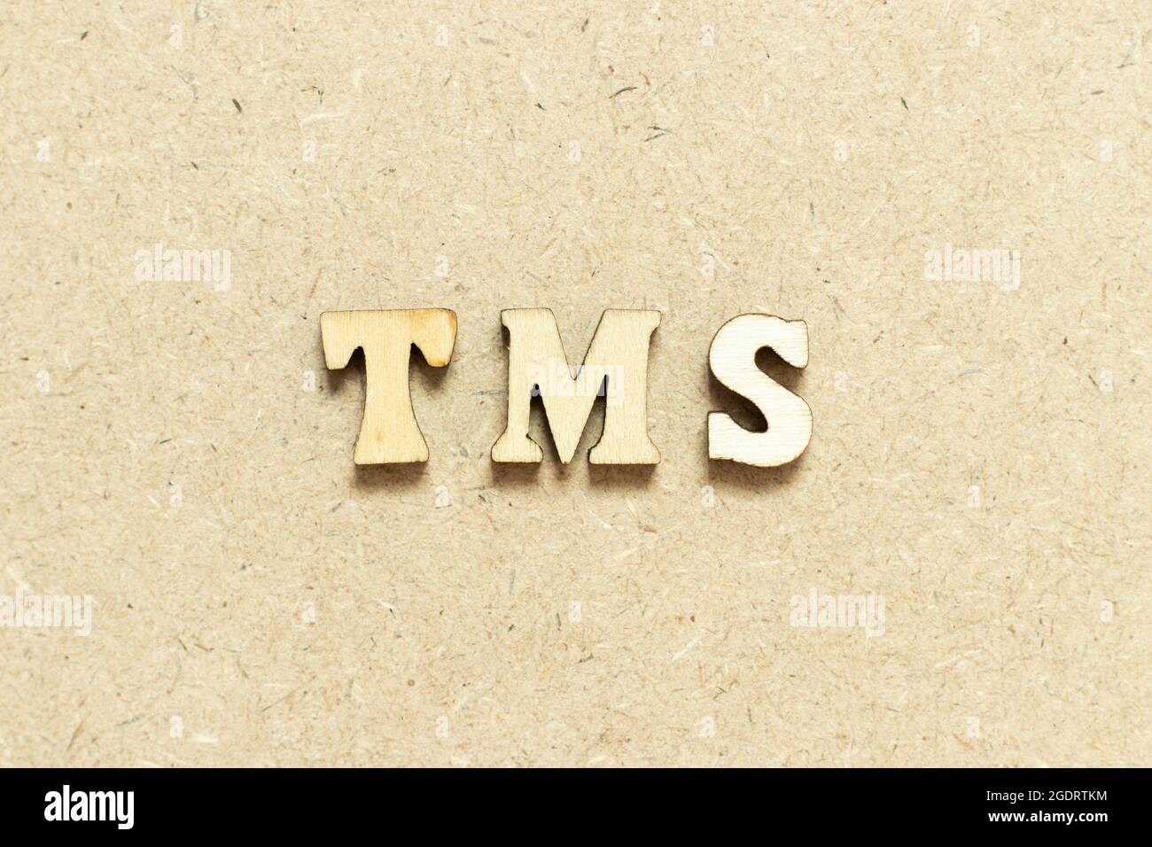 Alphabet letter in word TMS (Abbreviation of Transportation management system or Transcranial magnetic stimulation) on wood background Stock Photo