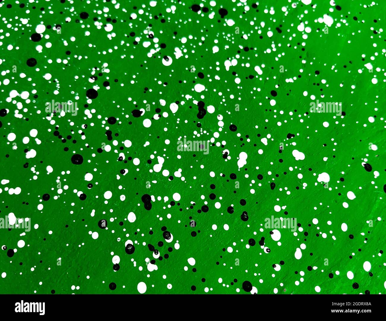 Green cement wall decorated with black and white dots pattern style. Stock Photo