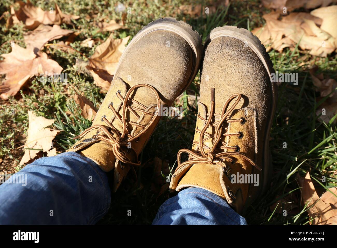 Feet in boots on grass background Stock Photo Alamy