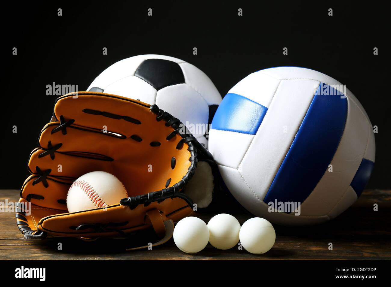 Sports balls on black background Stock Photo - Alamy