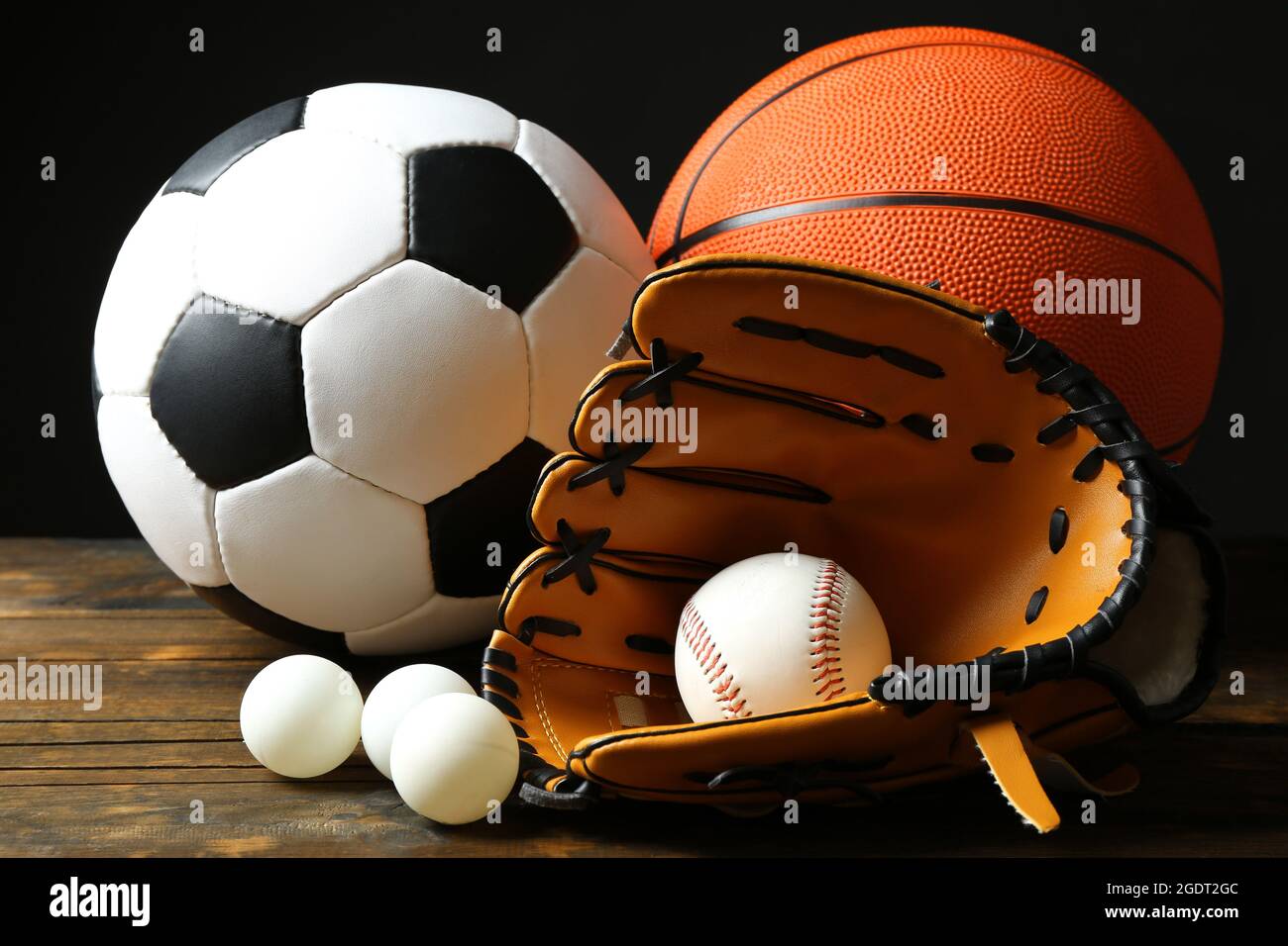 Sports balls on black background Stock Photo - Alamy
