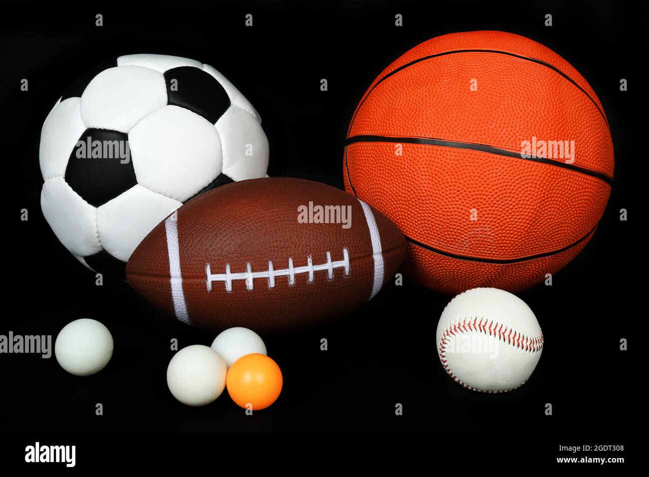 Sports balls on black background Stock Photo - Alamy