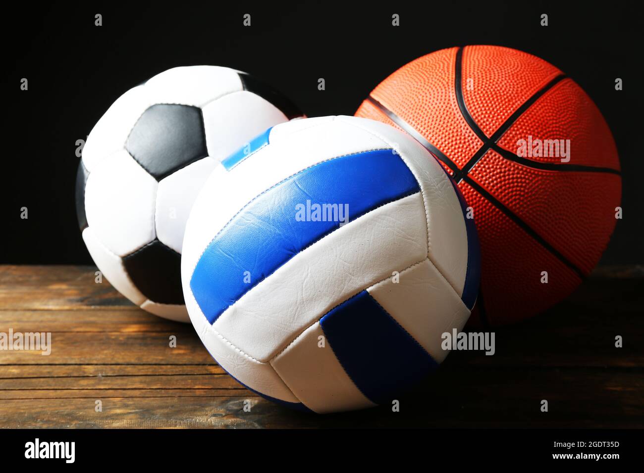 Sports balls on black background Stock Photo - Alamy