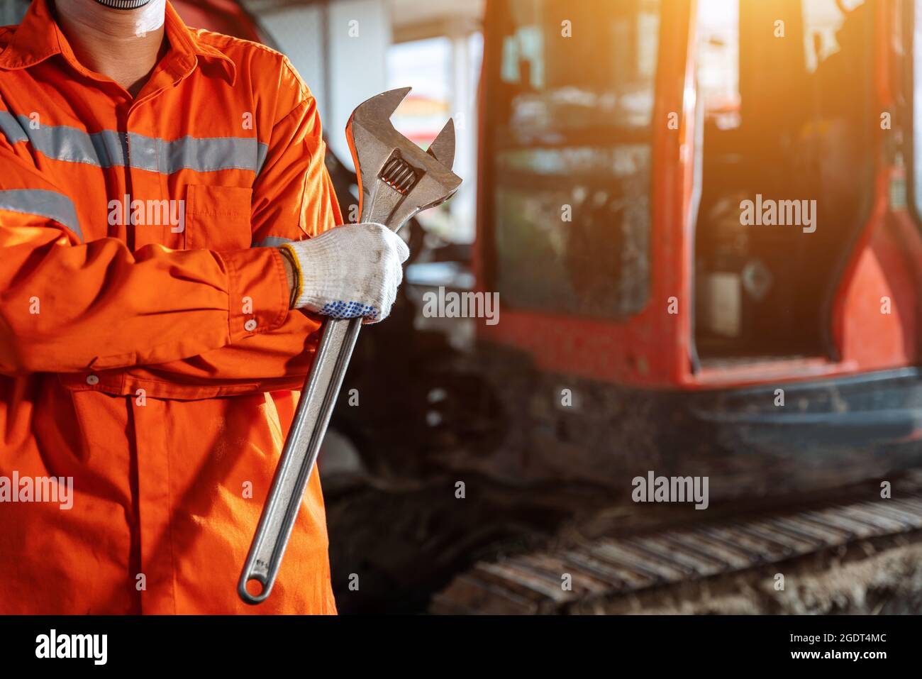 close up hand of excavator repair technician with large iron wrench in a hand, Powerful