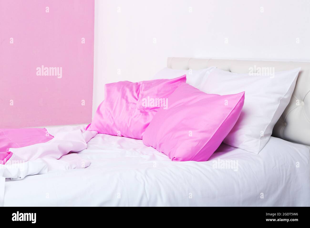 Bed in pink bed linen in room Stock Photo Alamy