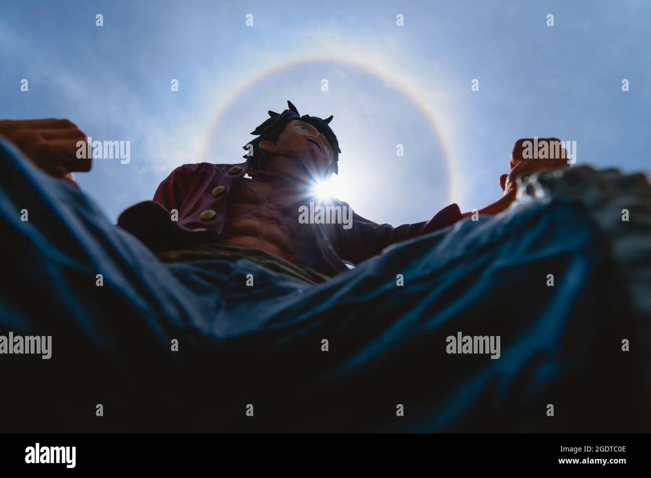 Bangkok, Thailand - August 14, 2021 : Plastic figurine of Money D.Luffy from One Piece animation with fantastic sun halo. Editorial use only Stock Photo