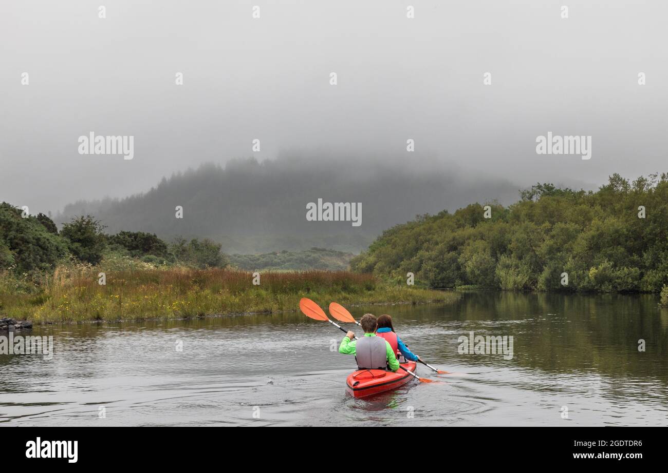 Ballingeary, Cork, Ireland. 14th August, 2021. On a misty day Emer and David Delaney spend their morning kayaking on Lough Aulla outside Inchigeelagh, Co. Cork, Ireland.  - Picture; David Creedon / Alamy Live News Stock Photo