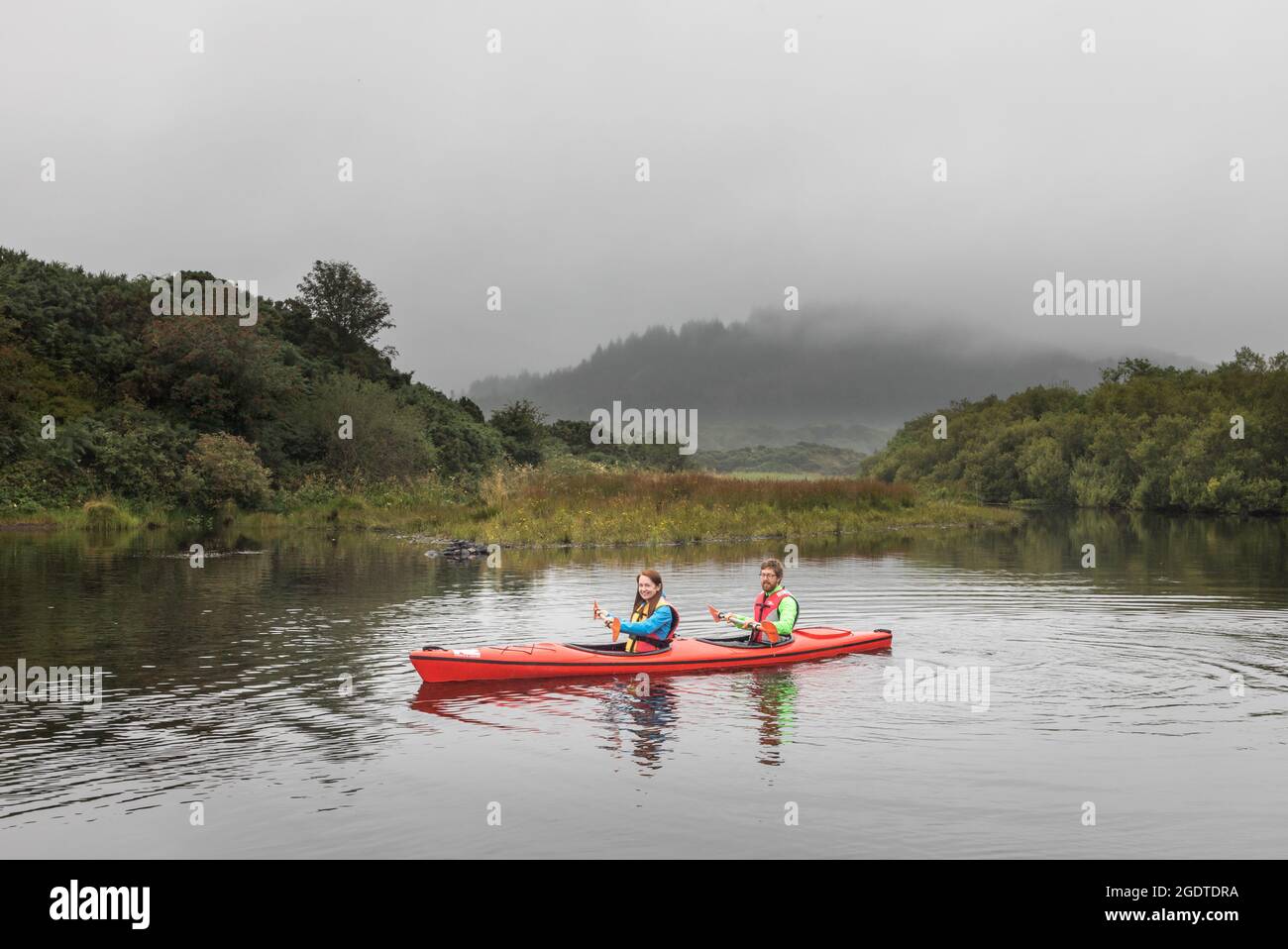 Ballingeary, Cork, Ireland. 14th August, 2021. On a misty day Emer and David Delaney spend their morning kayaking on Lough Aulla outside Inchigeelagh, Co. Cork, Ireland.  - Picture; David Creedon / Alamy Live News Stock Photo