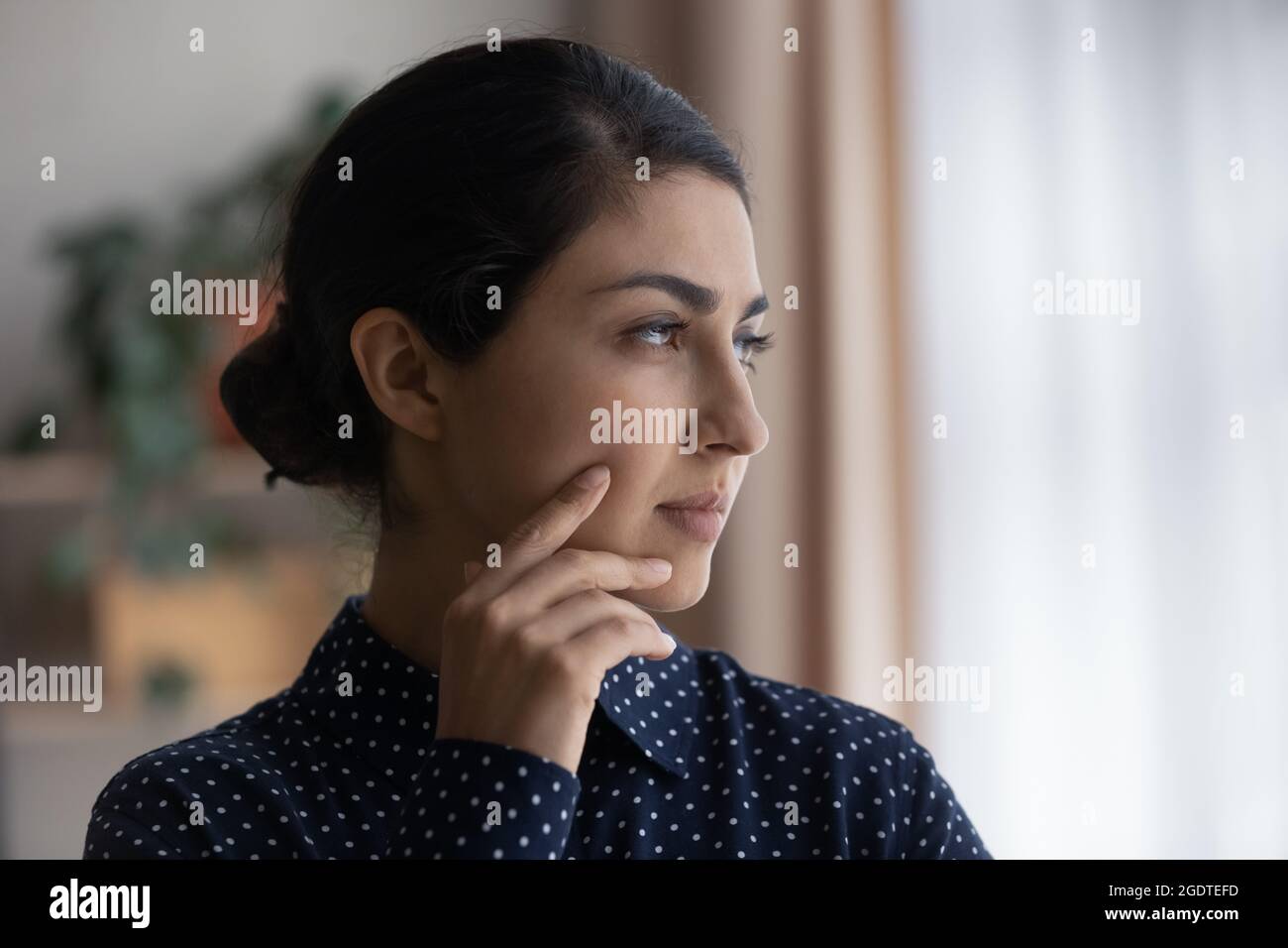 Pensive Indian woman look in distance thinking Stock Photo - Alamy