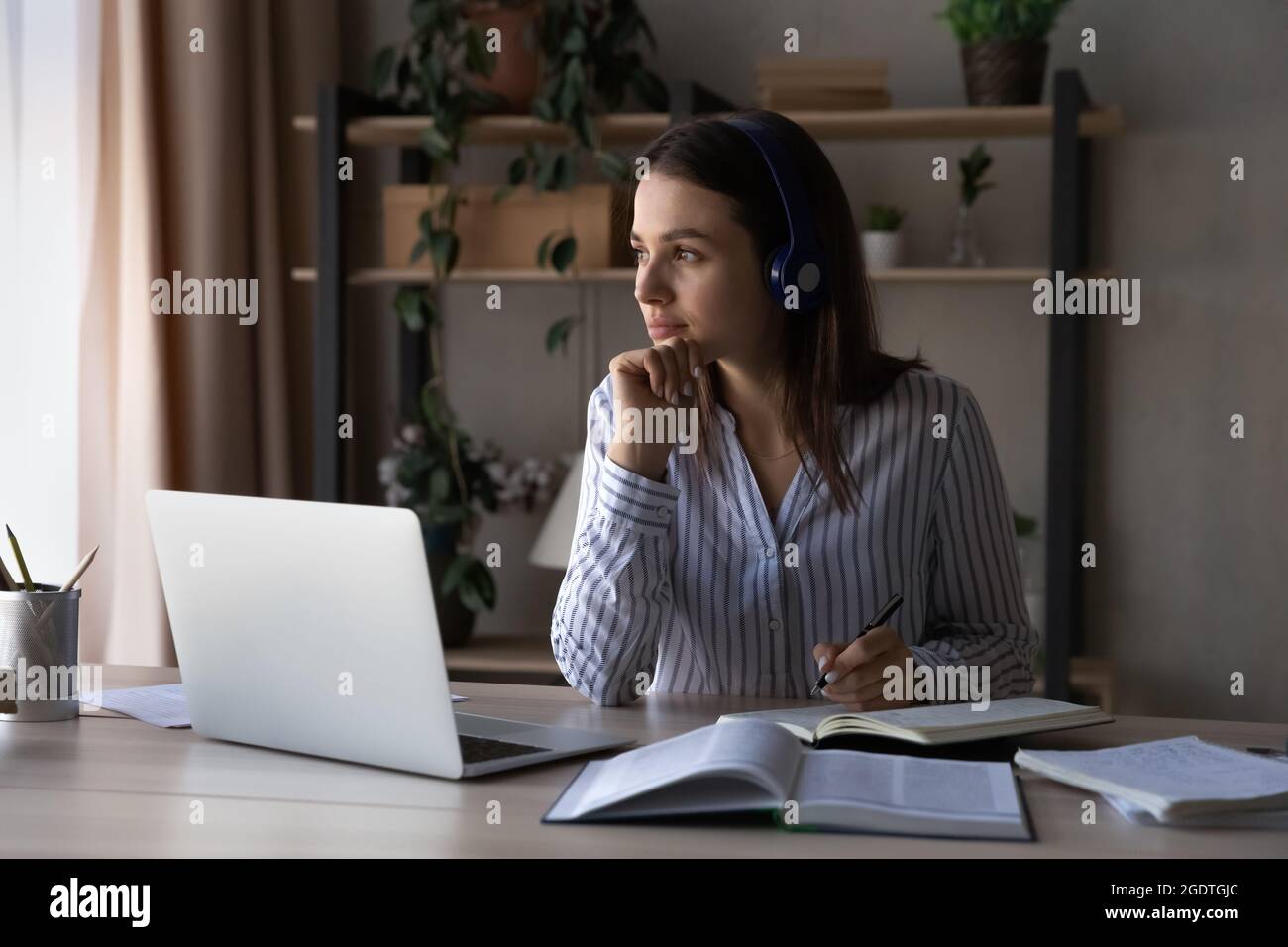 Pensive young woman study on laptop thinking Stock Photo - Alamy