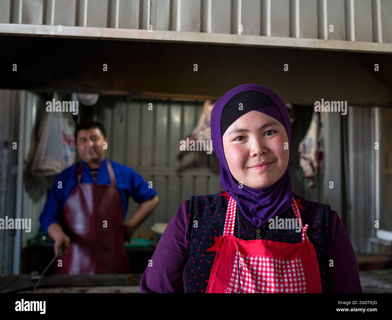 Kyrgyzstan, smiling girl in the uigur market Stock Photo