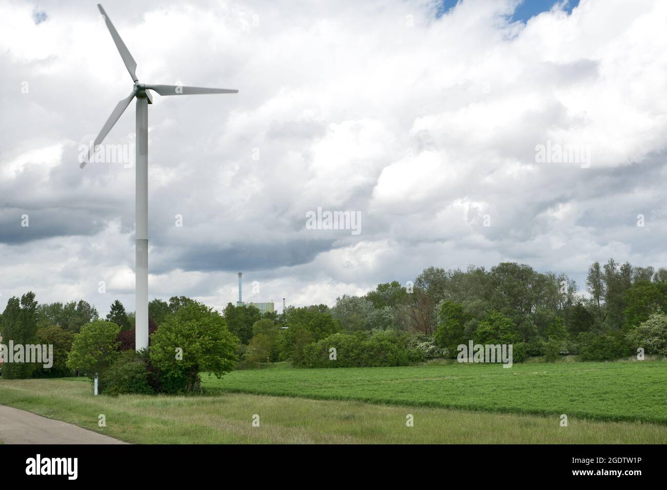 Karlsruhe, Maxau, Germany: Wind turbine with thunderstorm sky and green landscape Stock Photo