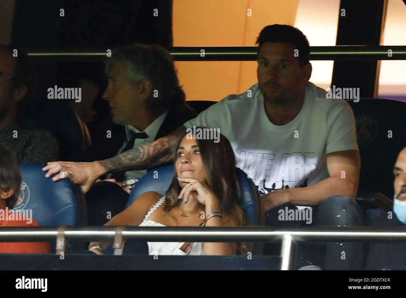 Paris SaintGermain's Argentinian forward Lionel Messi (R) watches the French L1 football match